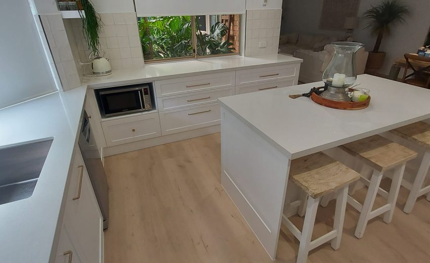 Bright white kitchen with island and natural window light